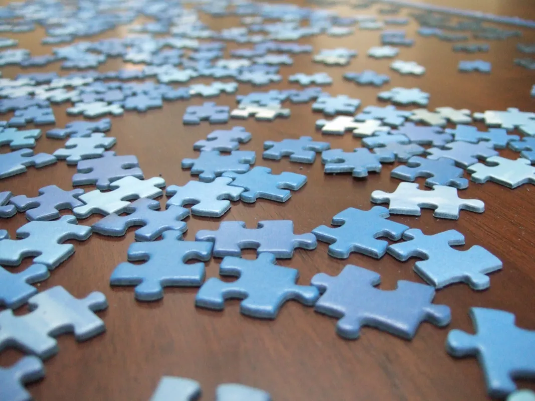 Jigsaw puzzle pieces spread on a table